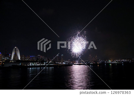 A vibrant city skyline at night near Yokohama Port with lights and boats 126978363