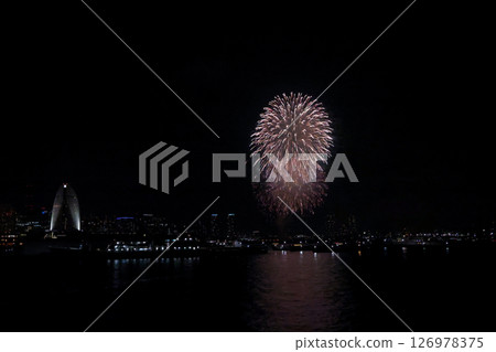 A vibrant city skyline at night near Yokohama Port with lights and boats 126978375