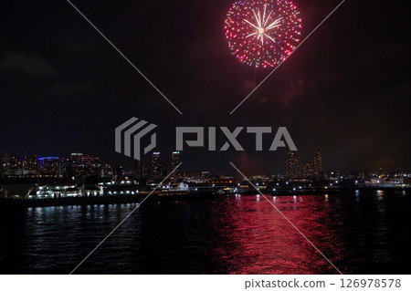 Fireworks display over Yokohama Port during a lively festival celebration at night 126978578