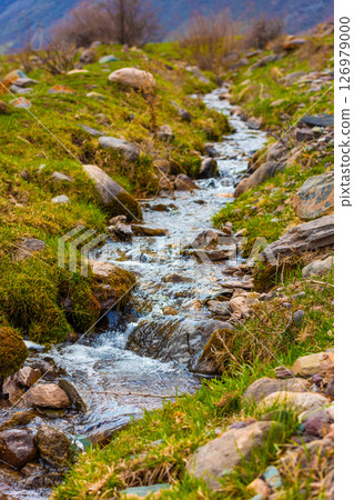 Clear stream flowing over mossy rocks. Clear stream flowing over mossy rocks. 126979000