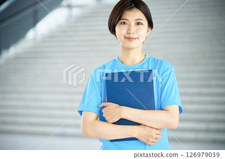 A young female caregiver working at a facility 126979039