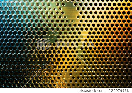 Colorful reflections on a metallic surface create an ethereal atmosphere in a dimly lit space 126979988