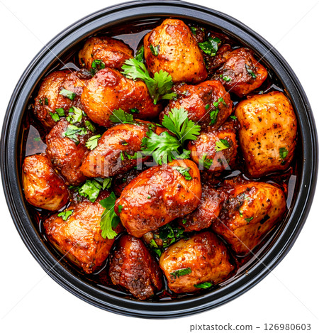 Crispy Spiced Potatoes Garnished with Fresh Green Herbs and Rich Sauce 126980603