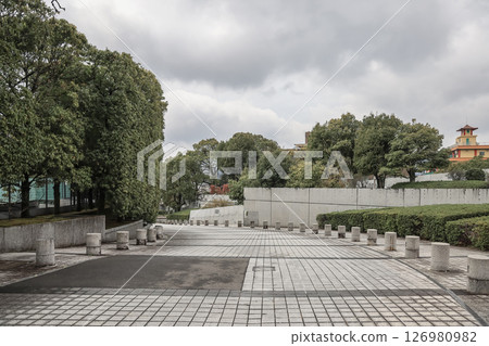 March 28 2025 Peaceful Urban Park with Trees and Paved Walkway 126980982