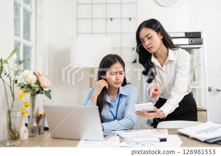 Guiding Colleague Through Challenges. Businesswoman providing direction to her stressed colleague in the office. 126981553