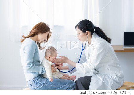 Doctor examining a baby Doctor examining a baby 126982164