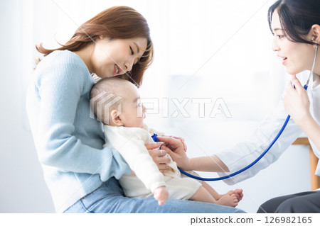 Female doctor examining a baby 126982165