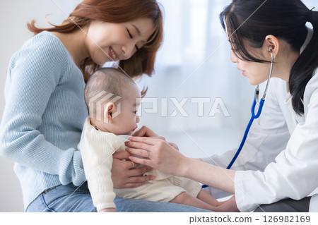 Baby receiving medical examination 126982169