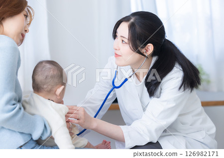 Female doctor examining a baby 126982171