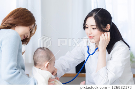 Female doctor examining a baby Female doctor examining a baby 126982173
