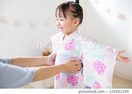 A 2-year-old girl wearing a yukata. Children's yukata dressing 126982200