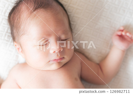 Sleeping face of a one-month-old baby 126982711