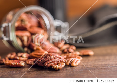 Peeled pecan nuts on wooden table. 126982846