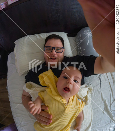 Father and Baby Selfie on Bed 126982872