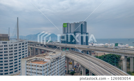 May 25 2025 Large Seaport with Stacked Containers and Cranes in Urban Area 126983054