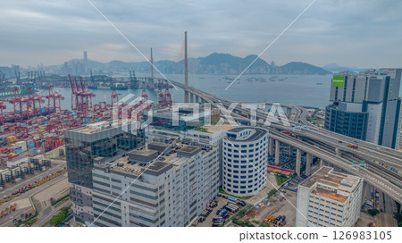 May 25 2025 Large Seaport with Stacked Containers and Cranes in Urban Area 126983105