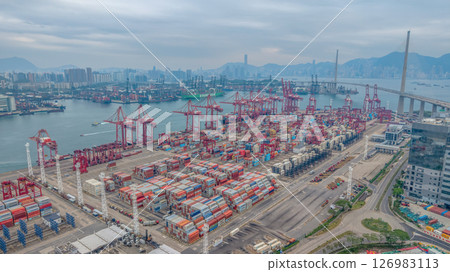 May 25 2025 Large Seaport with Stacked Containers and Cranes in Urban Area 126983113