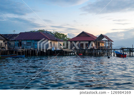 Fishermen houses at sunset, Pulau Papan, Malenge, Sulawesi, Indonesia 126984169