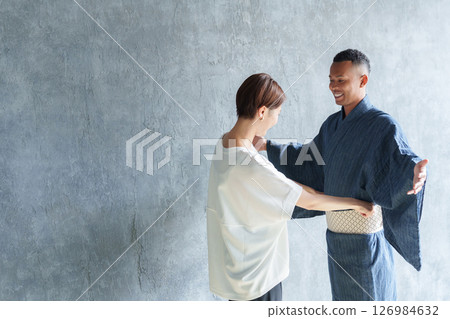 Staff helping foreign tourists put on yukata 126984632