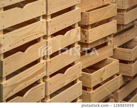 Empty wooden boxes or containers for fruit and vegetables stacked in warehouse 126985059