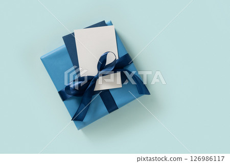 Happy Fathers Day gift box and blank on pastel blue background. Flat lay. View from above. Copy space. 126986117
