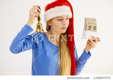 Christmas woman holding calendar and bell 126987470
