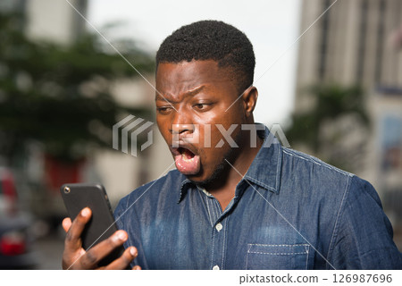 Funny worker looking at the phone screen and screaming. 126987696