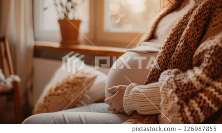Pregnant woman on the sofa in the living room. 126987855