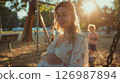 Pregnant woman on a walk in the park. 126987894
