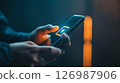 Smartphone with low battery in hands. 126987906