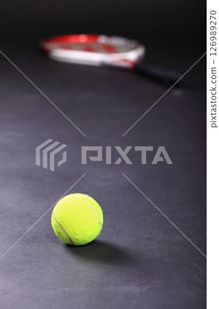 tennis racket and balls on black background 126989270