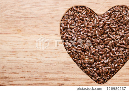 Raw flax seeds linseed heart shaped Raw flax seeds linseed heart shaped 126989287