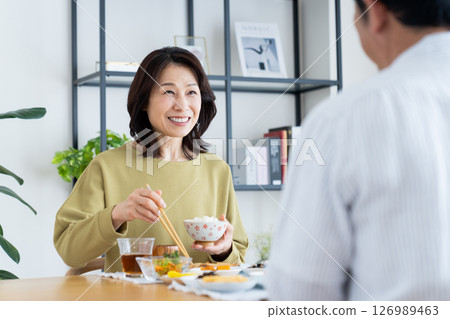 Middle-aged couple eating 126989463