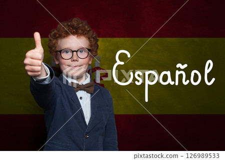 Successful child boy on Spanish flag with the inscription Espanol in Spanish. Successful child boy on Spanish flag with the inscription Espanol in Spanish. 126989533