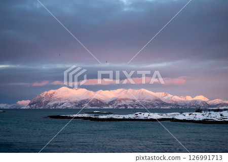 Sea mountains with snow in the sunset, Norway Sea mountains with snow in the sunset, Norway 126991713