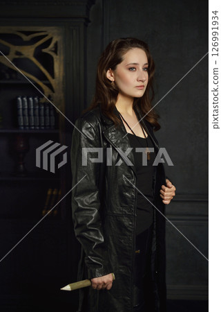 A young girl with dark hair poses as Buffy the vampire hunter A young girl with dark hair poses as Buffy the vampire hunter 126991934