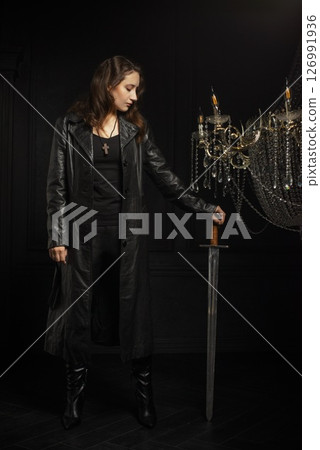 A young girl with dark hair poses as Buffy the vampire hunter A young girl with dark hair poses as Buffy the vampire hunter 126991936