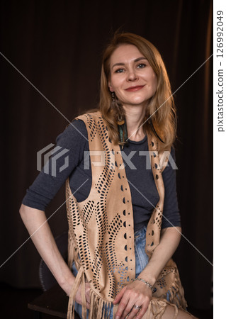 A young girl poses in a boho style suede vest. A young girl poses in a boho style suede vest. 126992049