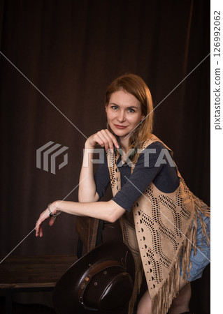 A young girl poses in a boho style suede vest. 126992062