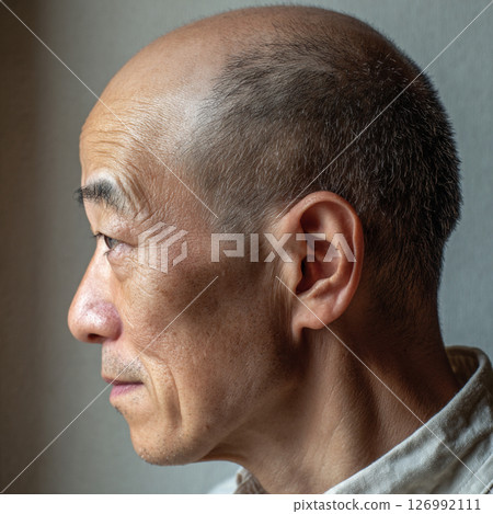 Profile portrait of a senior man with a thoughtful expression Profile portrait of a senior man with a thoughtful expression 126992111