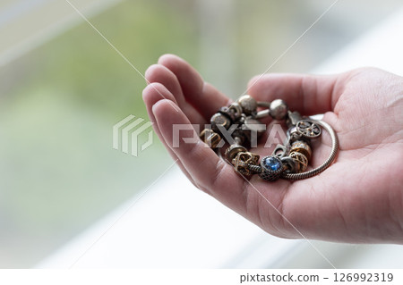 Man holding the oxidated jewellery. Closeup, selective focus. 126992319