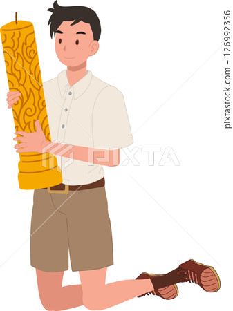 thai student boy kneeling with buddhist lent candle during temple ceremony. 126992356