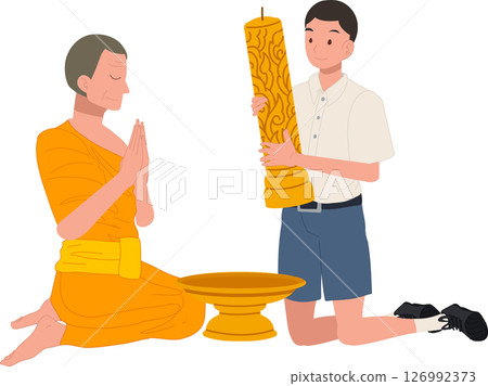 A young Thai student offers a candle to a monk during Khao Phansa at a temple 126992373