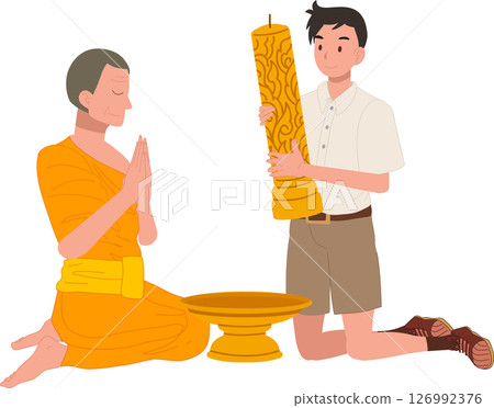A young Thai student offers a candle to a monk during Khao Phansa at a temple 126992376