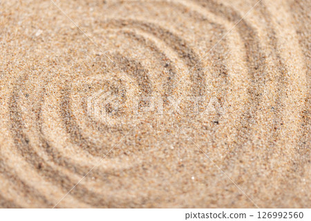Close-up view of fine sand forming spiral shapes, abstract photo 126992560