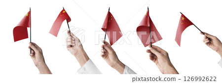 The China flag in hand in different angles on a white background 126992622