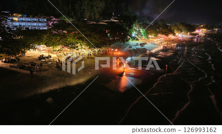 Tourists enjoying nightlife on tropical beach with fire shows in thailand 126993162