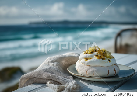 Tropical pavlova with kiwi served seaside on breezy whitewashed Australian coastal table Tropical pavlova with kiwi served seaside on breezy whitewashed Australian coastal table 126994932