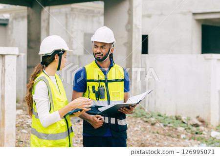 Construction Engineer team, Engineers teamwork man and women working together at construction site 126995071