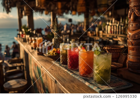 Tiki Bar Cocktails at Sunset with Bamboo Counter and Ocean Backdrop 126995330